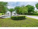 Welcoming community entrance with a decorative fountain, lush landscaping, and a gatehouse at 442 Devon Pl, Lake Mary, FL 32746