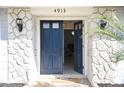 Open front door revealing the interior of the house with stone detail at 4913 E Wind St, Orlando, FL 32812
