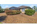 Well-manicured backyard featuring lush greenery, a screened-in lanai, and attractive landscaping at 8712 Sw 83Rd Cir, Ocala, FL 34481