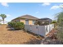 Fenced backyard with manicured rock landscaping, healthy shrubs, and a screened in patio at 8712 Sw 83Rd Cir, Ocala, FL 34481