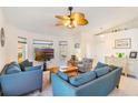 Bright living room featuring an elegant ceiling fan, modern furniture, neutral walls and tile floors at 100 Diamond Ridge Blvd, Auburndale, FL 33823