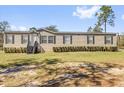 A charming single-story home with vinyl siding and a manicured lawn at 11811 Kijik Trl, Groveland, FL 34736