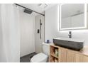 Modern bathroom with a sleek black sink, wood-look vanity, walk-in shower, and LED mirror at 1269 Winter Green Way, Winter Garden, FL 34787