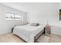 Bright bedroom with light wood floors, neutral walls, and a large window at 1269 Winter Green Way, Winter Garden, FL 34787