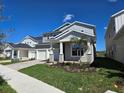 Charming two-story home with a well-maintained lawn, and a welcoming front porch at 13217 Tollcross Way, Winter Garden, FL 34787