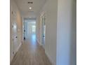 Bright hallway featuring tile flooring, white walls, and a view into the main living area at 13217 Tollcross Way, Winter Garden, FL 34787