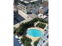 A stunning pool with lounge chairs surrounded by verdant landscaping offering a relaxing oasis at 155 S Court Ave # 2106, Orlando, FL 32801