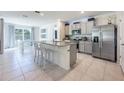 Modern kitchen with stainless steel appliances, granite countertops, and a center island with seating at 1671 Spray Ter, St Cloud, FL 34771