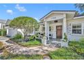 Inviting front porch featuring elegant columns, stone walkway, and attractive landscaping at 1750 Winchester Dr, Winter Park, FL 32789