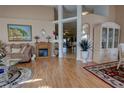 Inviting living room with high ceilings, wood floors, fireplace, and decorative accents, creating a cozy atmosphere at 304 Silver Pine Dr, Lake Mary, FL 32746