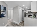 Hallway view of kitchen with stainless steel appliances and granite countertops at 3208 Sabal Palms Ct # A, Kissimmee, FL 34747