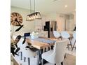 Inviting dining area with a rustic wood table, stylish lighting, and modern chairs at 333 Jovana Rd, Davenport, FL 33837