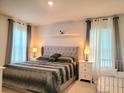 Serene main bedroom with a king-size bed, soft lighting, and elegant curtains at 333 Jovana Rd, Davenport, FL 33837