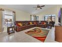 Bright living room featuring tile floors, a leather sectional, and natural light at 340 Grand Canal Dr, Poinciana, FL 34759