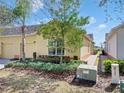 Single-story home featuring a well-maintained lawn, colorful landscaping, and an attached two-car garage at 3640 Solana Cir # A, Clermont, FL 34711