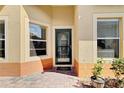 Welcoming front entryway features decorative door, windows, and brick-paved porch at 3640 Solana Cir # A, Clermont, FL 34711