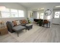 Bright and airy living room with neutral tones, plush seating, and stylish decor, adjacent to the dining area at 3708 Merryweather Dr, Orlando, FL 32812