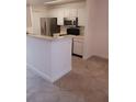 Kitchen with stainless steel refrigerator and white cabinets at 4275 Perkinshire Ln # 204, Orlando, FL 32822