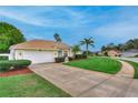 Beautifully landscaped front yard with green lawn and a two-car garage at 460 Quail Hill Dr, Debary, FL 32713