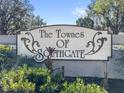 The Townes of Southgate community sign surrounded by greenery against a clear blue sky at 4713 Capri Pl # 190, Orlando, FL 32811