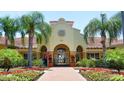 Community building with lush landscaping and a brick walkway leading to the entrance at 5000 Cayview Ave # 10108, Orlando, FL 32819