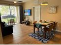 Bright dining area with wood-look tile floors and a sliding glass door to the balcony at 5000 Cayview Ave # 10108, Orlando, FL 32819