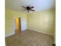 Bedroom with neutral walls, plush carpeting, ceiling fan and closet space for storage at 5105 City St # 817, Orlando, FL 32839