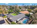 An overhead view reveals the home's layout, screened pool, and spacious backyard in a residential neighborhood at 5140 Honeynut Ln, Windermere, FL 34786