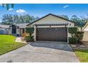 Front of a home featuring a two-car garage with pergola accent at 5140 Honeynut Ln, Windermere, FL 34786