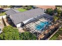 A screened-in pool is surrounded by a patio and lush landscaping at 5140 Honeynut Ln, Windermere, FL 34786