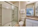 Well-lit bathroom featuring a glass-enclosed shower, granite countertop and vanity with a sink at 6090 Broad Oak Dr, Davenport, FL 33837