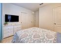 Comfortable bedroom with a plush bed, neutral decor, and a mounted TV at 6090 Broad Oak Dr, Davenport, FL 33837