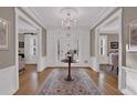 Elegant foyer with hardwood floors, chandelier, and classic architectural details create a welcoming entrance at 721 Delaney Ave, Orlando, FL 32801