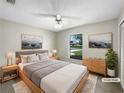 Comfortable staged main bedroom with a large window, neutral tones, and ample natural light at 832 Yellowbird Ave, Deltona, FL 32725