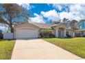 Inviting single-story home with a spacious driveway leading to an attached two-car garage at 970 Picasso Ave, Deltona, FL 32738