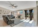 Relaxing living room with a plush sectional sofa, a large TV, and sliding glass doors to the backyard at 970 Picasso Ave, Deltona, FL 32738