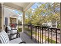 Relax on this cozy balcony with wrought iron railings and beautiful views of the neighborhood at 1531 Lake Baldwin Ln, Orlando, FL 32814