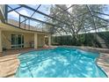 A screened-in pool with a waterfall feature, creating a backyard oasis for relaxation and enjoyment at 1657 Cherry Ridge Dr, Lake Mary, FL 32746