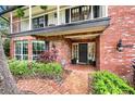 Brick home showcasing a beautiful entrance with a welcoming front porch at 1804 Wind Willow Rd, Belle Isle, FL 32809