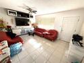 Bright living room with tile floors, ceiling fan, and plenty of space at 1808 4Th Se Ct, Winter Haven, FL 33880