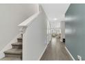 Hallway with wood flooring and a staircase leading to the upper level at 208 Cape Honeysuckle Pl, Sanford, FL 32771