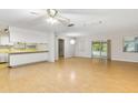 Bright living room featuring wood floors, neutral colors, and access to kitchen and outdoor area at 257 Sheppard St, Altamonte Springs, FL 32701