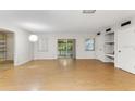 Spacious living room featuring wood floors, natural light, built in shelves and access to the back porch at 257 Sheppard St, Altamonte Springs, FL 32701