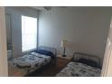 Simple bedroom with twin beds, natural light, and functional decor at 2739 N Poinciana Blvd # 84, Kissimmee, FL 34746