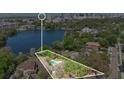 An aerial view displaying the property's boundary lines with a pool surrounded by trees and proximity to the city skyline at 321 E Copeland Dr, Orlando, FL 32806