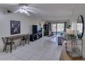 Bright living room with tile floors, modern decor, and access to outdoor balcony at 3467 Flossmoor Ave # 101, Orlando, FL 32822