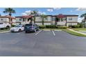 Convenient condo parking with designated parking spaces and lush landscaping at 3467 Flossmoor Ave # 101, Orlando, FL 32822