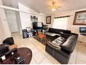 Cozy living room featuring tile floors, a ceiling fan and plenty of space for relaxing and entertaining at 4954 Luna Negra Dr, Orlando, FL 32811