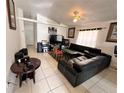 Spacious living room with tile flooring, vaulted ceiling and ample natural light at 4954 Luna Negra Dr, Orlando, FL 32811