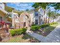 View of condo exterior with well-maintained landscaping and brick archway at 5007 Laguna Bay Cir # 31, Kissimmee, FL 34746